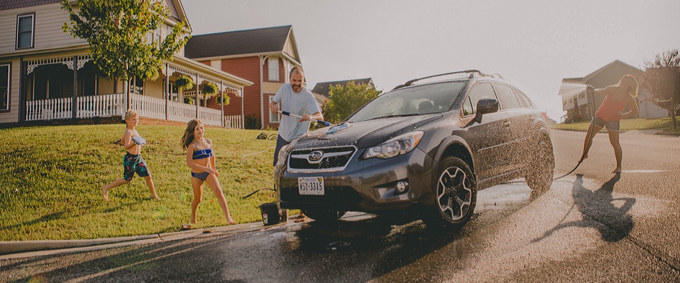 Family having fun washing car