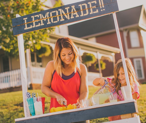 Woman and daughter working lemonade stand